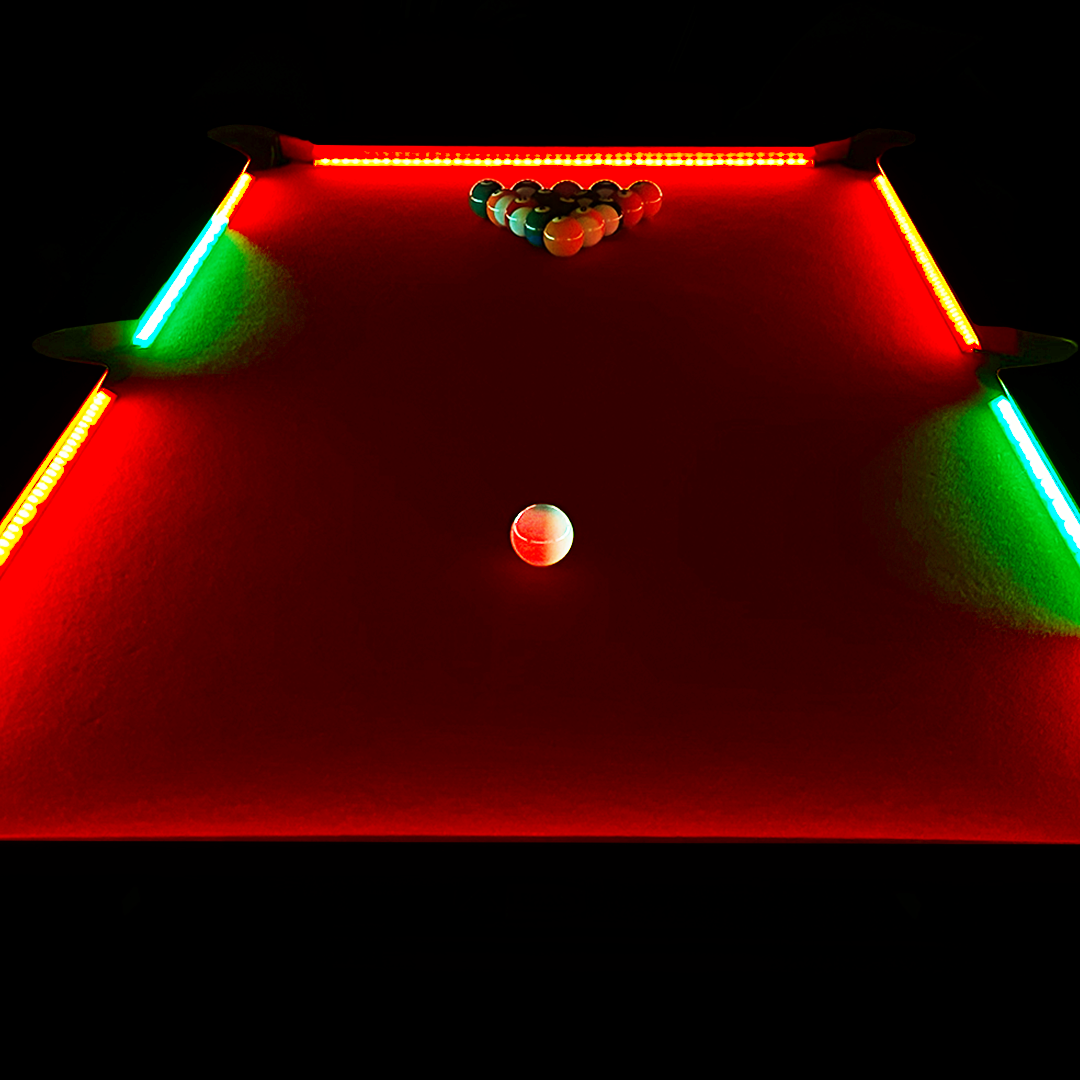 Pool table with red and green lights on a black background